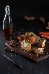 Homemade carrot cakes with pecans on dark wooden