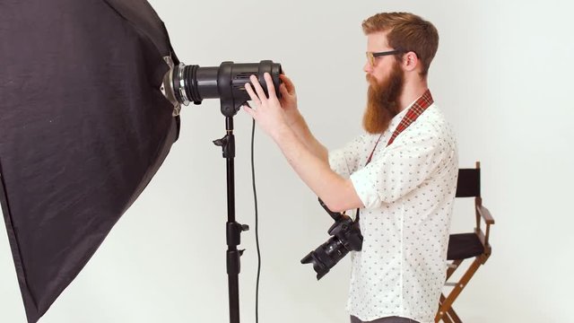 A photographer is installing a camera for shooting in a studio.