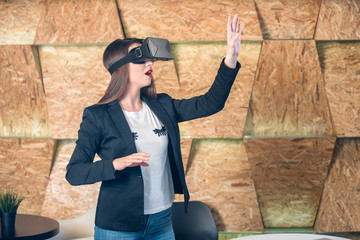 Girl using VR glasses having fun