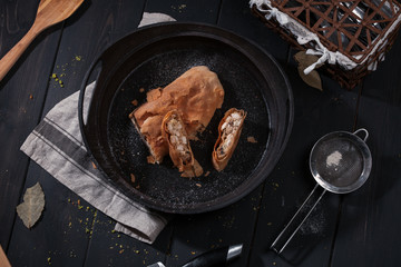 Top view of home strudel with chicken in frying pan