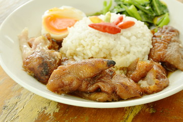 pork trotters stew and boiled egg with rice on plate