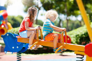 Fototapeta na wymiar Kids on playground. Children play in summer park.