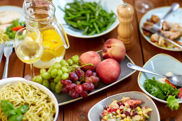 fruits, salads and pasta on wooden table