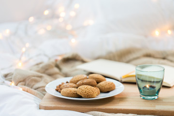 oatmeal cookies and candle in holder at home