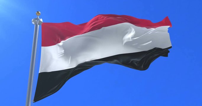 Flag of Yemen waving at wind in slow with blue sky, loop