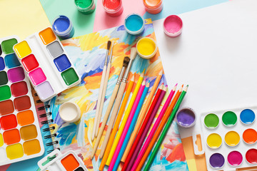 paints, pencils and brushes on paper