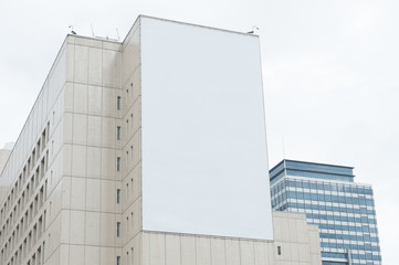 Large blank billboard on a street wall, banners with room to add your own text - Powered by Adobe