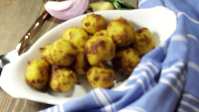 Gluten free Moong Daal goli or mung lentil spicy balls cooked in a spicy masala.
