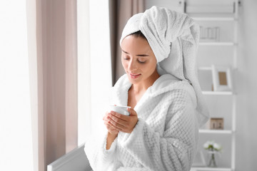 Morning of young beautiful woman drinking coffee in room