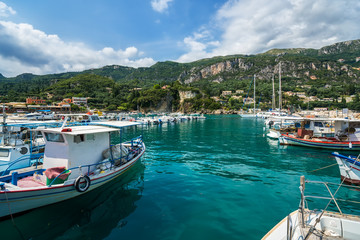 Yachts, boats and sailor ships parking in Paleokastritsa bay, Corfu, Greece.