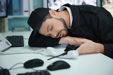 Male security guard sleeping at workplace