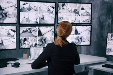 Female security guard working in surveillance room