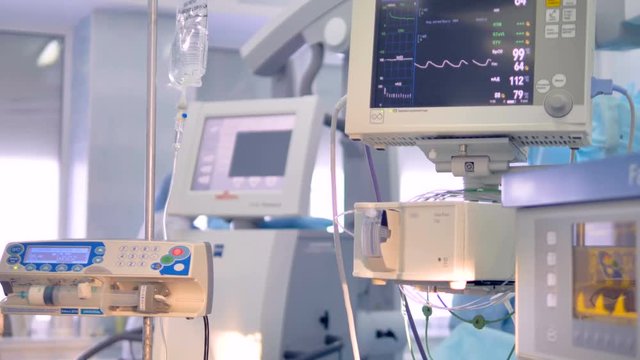 Medical device ecg monitor in surgery shows patients parameters - heartbeat, blood pressure.