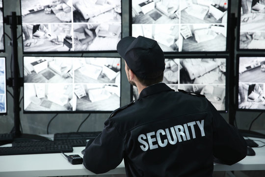 Male security guard working in surveillance room