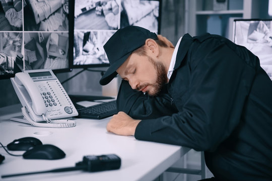 Male security guard sleeping at workplace