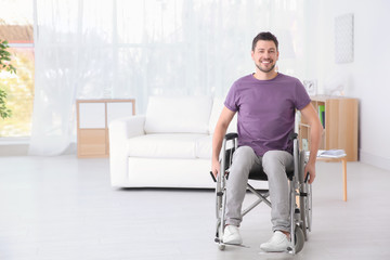 Young man in wheelchair indoors