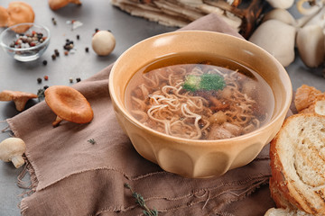 Bowl with mushroom soup on table