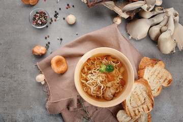 Bowl with mushroom soup on table