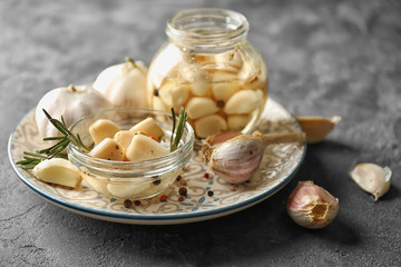 Preserved garlic in glassware on plate