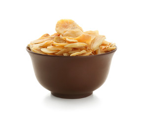 Dried garlic flakes in bowl on white background