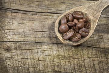 Roasted coffee on the wooden background - Coffea