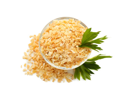 Bowl with granulated dried garlic on white background