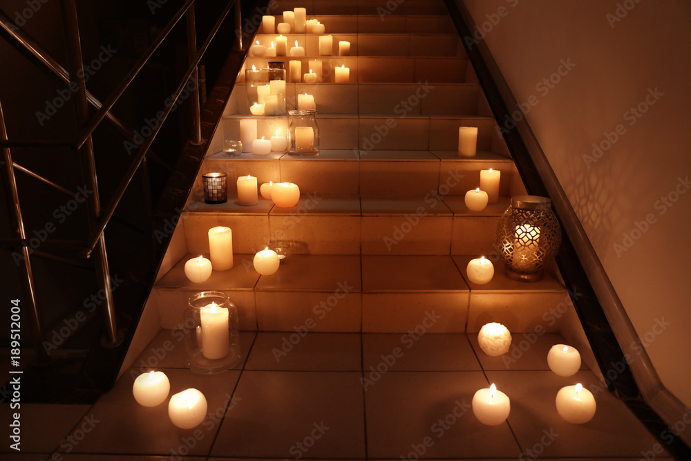 Wall mural burning candles on stairs