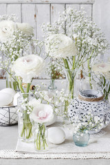 Floral arrangement with ranunculus flowers and white gypsophila paniculata.