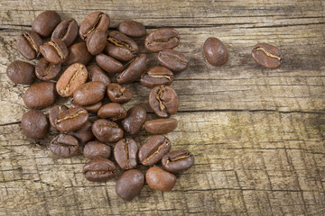 Roasted coffee on the wooden background - Coffea