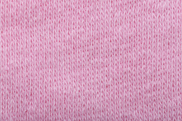 Pink knitted fabric texture as background, closeup