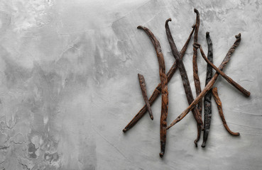 Fototapeta na wymiar Vanilla sticks on grey background
