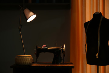 Vintage sewing machine in tailor's workshop