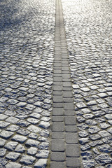 Cobbled street in early morning golden light.