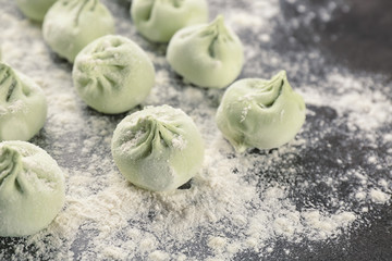 Raw khinkali dumplings on table, closeup
