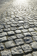 Cobbled street in early morning golden light.