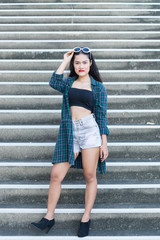 Fototapeta premium Portrait of beautiful asian woman,Hipsters girl for take a picture outdoor,Thailand people stand on stair
