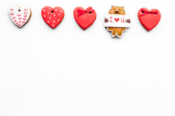 Sweets on Valentine's Day. Cookies in shape of heart and with lettering I love you on white background top view copy space
