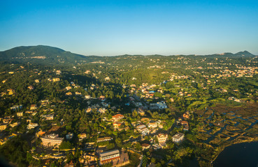 Aerial view from the aircraft window to the Corfu island at sunrise, Greece.