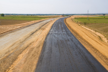 Fototapeta na wymiar Primera capa asfaltica en la construccion de una autopista
