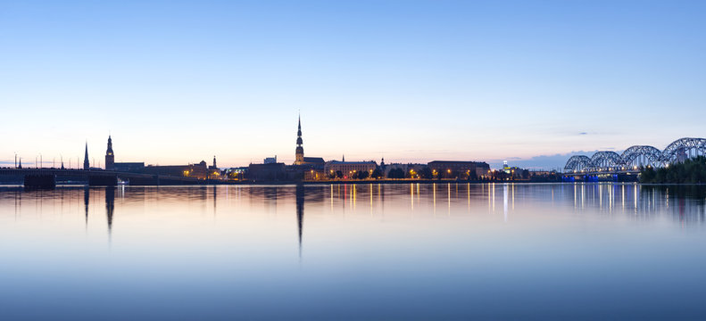 View on Riga cityline panorama in early morning over river Daugava. Panoramic montage from 11 images.