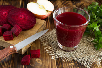 Beetroot and apple juice on the  rustic  wooden background