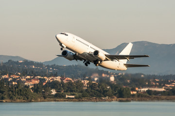 Fototapeta na wymiar Modern passenger airplane taking off at Corfu Ioannis Kapodistrias international airport.
