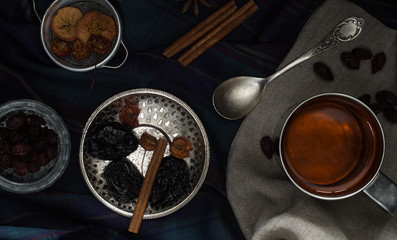 Various nuts and dried fruits in metal dishes on the table. Top view