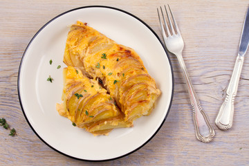 Potato gratin. Baked potato slices with creamy sauce. View from above, top, horizontal