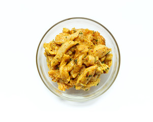 Indian chicken curry ready to cook. Marinated Chicken in chili, turmeric and different spices, isolated on white background.