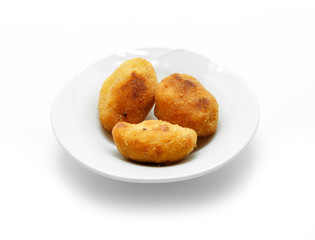Homemade traditional Spanish croquettes on a white plate and isolated on white background.