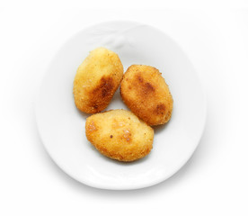 Homemade traditional Spanish croquettes on a white plate and isolated on white background.
