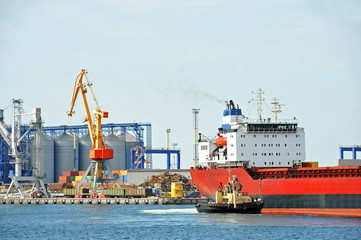 Tugboat assisting bulk cargo ship