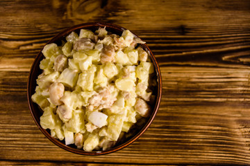 Salad with the haricot beans and meat dressed with mayonnaise in ceramic bowl. Top view