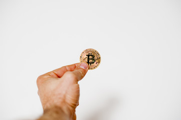 Fototapeta na wymiar bitcoin electronic coin holding in the hand white background